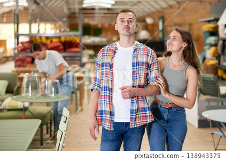 Cheerful couple browsing in home and garden furniture store Cheerful couple browsing in home and garden furniture store 138943375