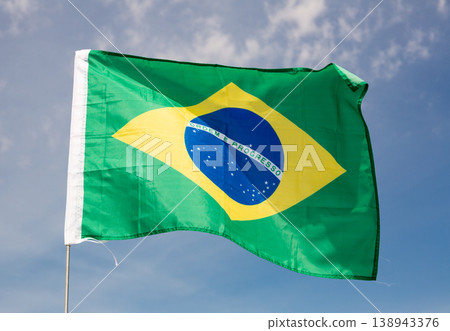 Brazil flag waving against blue sky 138943376