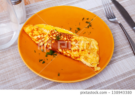 Portion of healthy omelet from lightly beaten eggs served for breakfast Portion of healthy omelet from lightly beaten eggs served for breakfast 138943380
