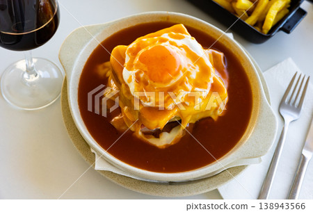 Francesinha served in bowl with beer sauce and fried egg Francesinha served in bowl with beer sauce and fried egg 138943566