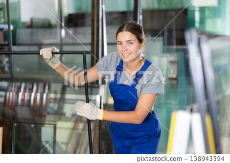 Female foreman inspecting plate glass cut to size Female foreman inspecting plate glass cut to size 138943594