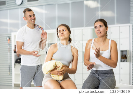 Girls rejecting attempt of guy to chat in gym locker room Girls rejecting attempt of guy to chat in gym locker room 138943639
