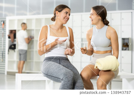 Female friends enjoying conversation in locker room of climbing gym 138943787