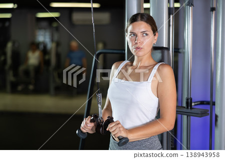 Young woman training with straps in gym Young woman training with straps in gym 138943958