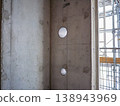 Concrete wall with pipe sleeve holes and markings at an RC (reinforced concrete) construction site. 138943969