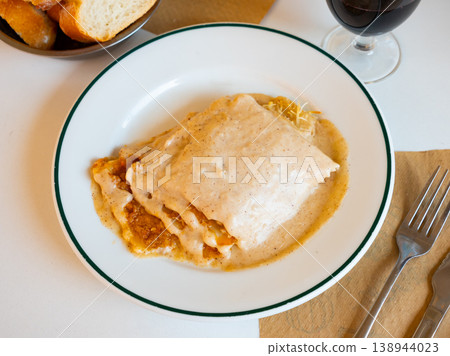 Meat lasagne with cheese served on platter Meat lasagne with cheese served on platter 138944023