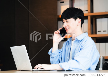 A young businessman talking on his smartphone A young businessman talking on his smartphone 138944773