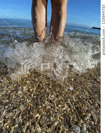 Splashes of water rising from your feet in the Okinawan sea - a summer beach moment. Splashes of water rising from your feet in the Okinawan sea - a summer beach moment. 138944785