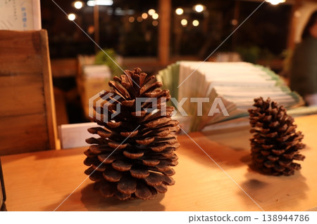 Natural interior decor featuring pine cones placed on a wooden table. Natural interior decor featuring pine cones placed on a wooden table. 138944786