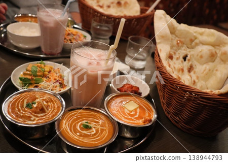 A set of authentic Indian food featuring colorful curries and naan. A set of authentic Indian food featuring colorful curries and naan. 138944793