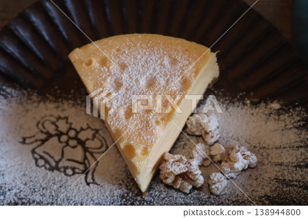 A cake dessert plate adorned with a bell pattern of powdered sugar. A cake dessert plate adorned with a bell pattern of powdered sugar. 138944800