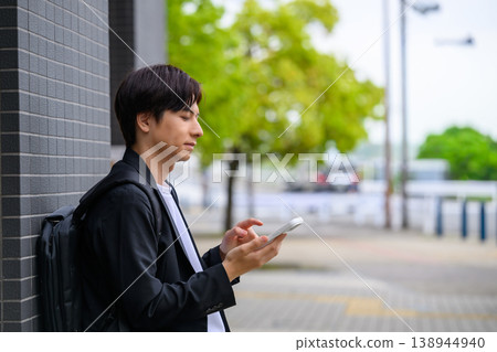 A man operating a smartphone 138944940