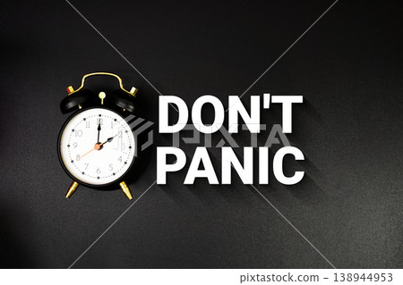 Don't Panic text with alarm clock on black background Don't Panic text with alarm clock on black background 138944953