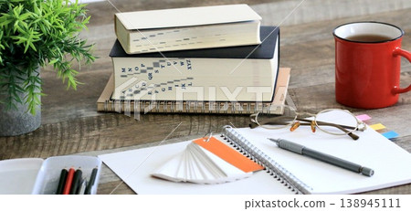 An image of intellectual learning expressed through glasses and a notebook. An image of intellectual learning expressed through glasses and a notebook. 138945111