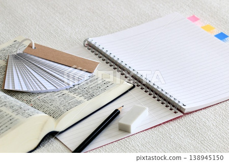 A learning image showing an English-Japanese dictionary and a notebook side by side. A learning image showing an English-Japanese dictionary and a notebook side by side. 138945150