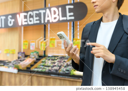 A male customer operating his smartphone A male customer operating his smartphone 138945458