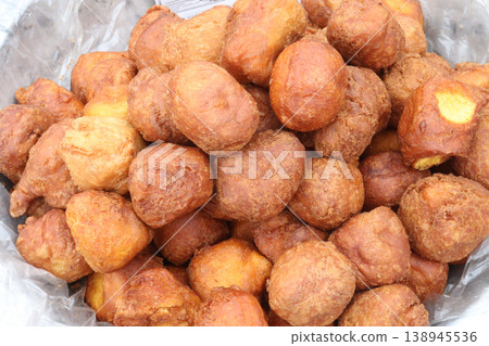 Puff-puff, fried dough balls made from a batter of flour, sugar, yeast, water Puff-puff, fried dough balls made from a batter of flour, sugar, yeast, water 138945536
