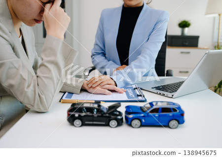 Insurance advisor comforting stressed customer during car accident claim consultation. Emotional support, financial assistance 138945675
