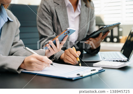 Team business meeting presentation. Hand businessman working project in modern office.Laptop computer and tablet and smart phone Team business meeting presentation. Hand businessman working project in modern office.Laptop computer and tablet and smart phone 138945725