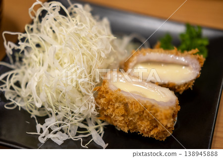 Tonkatsu, Fried Pork with cheese serve with cabbage on plate in restaurant Tonkatsu, Fried Pork with cheese serve with cabbage on plate in restaurant 138945888