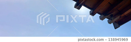 A simple composition of negative space: the eaves of a Japanese-style building and raindrops dripping into the blue sky. A simple composition of negative space: the eaves of a Japanese-style building and raindrops dripping into the blue sky. 138945969