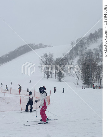 Niseko, Japan - April 3, 2025 : Snowboarders and skiers enjoy activities at Annupuri ski resort, Niseko, Hokkaido, Japan on April 3, 2025. Niseko, Japan - April 3, 2025 : Snowboarders and skiers enjoy activities at Annupuri ski resort, Niseko, Hokkaido, Japan on April 3, 2025. 138946365