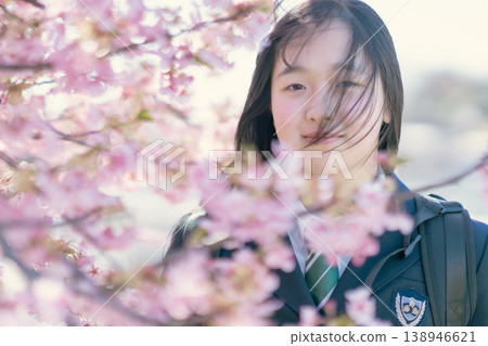 A female student shows a hopeful expression in the spring sunlight. Growth, beauty, skincare, graduation. A female student shows a hopeful expression in the spring sunlight. Growth, beauty, skincare, graduation. 138946621