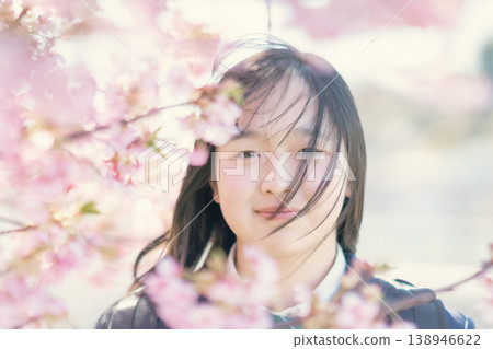 A female student shows a hopeful expression in the spring sunlight. Growth, beauty, skincare, graduation. A female student shows a hopeful expression in the spring sunlight. Growth, beauty, skincare, graduation. 138946622