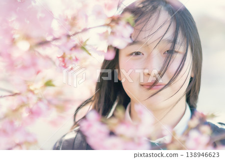 A female student shows a hopeful expression in the spring sunlight. Growth, beauty, skincare, graduation. A female student shows a hopeful expression in the spring sunlight. Growth, beauty, skincare, graduation. 138946623
