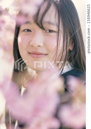 A female student shows a hopeful expression in the spring sunlight. Growth, beauty, skincare, graduation. A female student shows a hopeful expression in the spring sunlight. Growth, beauty, skincare, graduation. 138946625