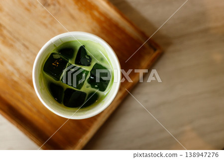 Cup of fresh iced matcha tea, green tea on wooden tray. Cup of fresh iced matcha tea, green tea on wooden tray. 138947276
