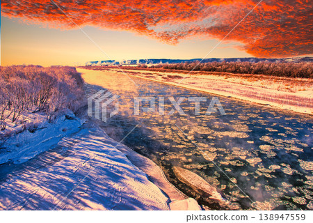 Snowy landscape of a frozen river in the midwinter Snowy landscape of a frozen river in the midwinter 138947559