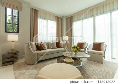 Light brown and white pillows on sofa in the living room with area rug. Light brown and white pillows on sofa in the living room with area rug. 138948022