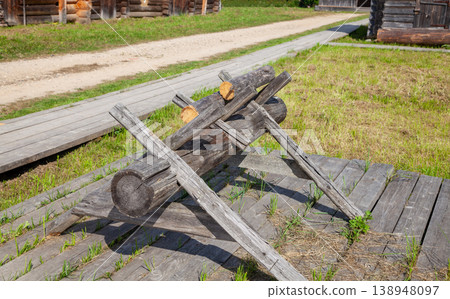 Wooden Sawhorses Near Traditional Village House Wooden Sawhorses Near Traditional Village House 138948097