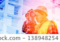 A geodesic engineer performs close-up survey work on a construction site behind a geodetic instrument. 138948254