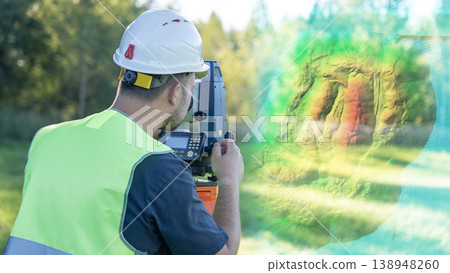 An engineer at work on a geodetic instrument. Geodesy surveying is the cadastral work of performing measurements of premises using a modern total station geodetic instrument. 138948260