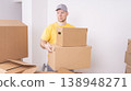 Workers a loader brings boxes indoors when moving in close-up 138948271