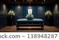 Funeral setting in a dark room with a casket and flowers during a memorial service 138948287