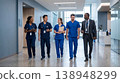 Healthcare workers walk together in hospital hallway during day shift discussing patient care and teamwork 138948299