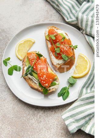 Salmon avocado toasts with cream cheese and microgreens Salmon avocado toasts with cream cheese and microgreens 138948479