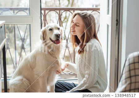 Woman and golden retriever dog sharing friendship moment Woman and golden retriever dog sharing friendship moment 138948517