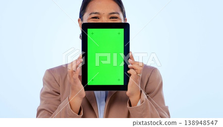 Portrait, tablet and green screen mockup with an asian woman in studio on a blue background for website promotion. Tech, space or chromakey and a person holding a display with tracking markers Portrait, tablet and green screen mockup with an asian woman in studio on a blue background for website promotion. Tech, space or chromakey and a person holding a display with tracking markers 138948547