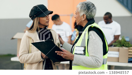 Women volunteering, checklist and food donation, NGO project or community service management and support. Nonprofit people or senior manager helping, talking and registration or clipboard for charity 138948557