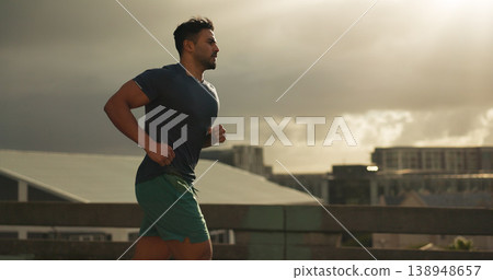 Running, city or man athlete in workout by training, cardio jog or fitness goals for marathon competition. Indian runner, wellness or progress in race, exercise or strong health body on urban road 138948657