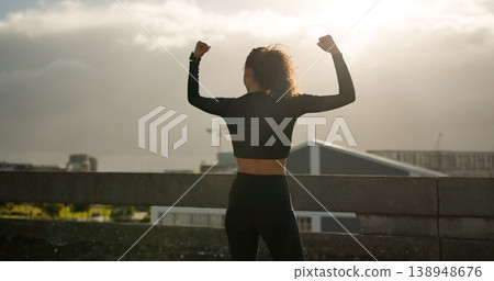 Woman, success and city for fitness achievement, workout or winning in outdoor training. Rear view of female person, runner or athlete in celebration for goals, sports or victory in an urban town 138948676