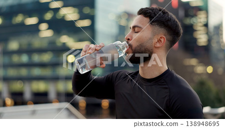 Man, drinking water and fitness in city after workout, exercise or outdoor training for natural sustainability. Thirsty male person with mineral drink in rest, recovery or break for hydration in town Man, drinking water and fitness in city after workout, exercise or outdoor training for natural sustainability. Thirsty male person with mineral drink in rest, recovery or break for hydration in town 138948695