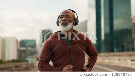 Mature, athlete and running in city with headphones for fitness, workout or marathon training music. Black man, thinking or exercise podcast in South Africa for cardio wellness, health or sport radio 138948753