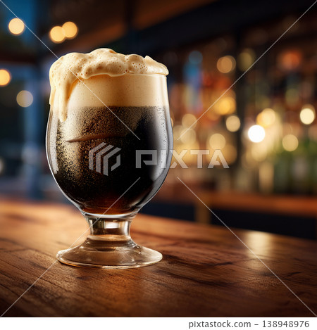 Frothy stout beer tall glass on a rustic wooden bar background, representing refreshment and rich beverage appeal Frothy stout beer tall glass on a rustic wooden bar background, representing refreshment and rich beverage appeal 138948976