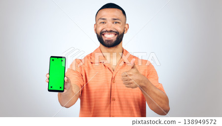 Portrait, man and thumbs up for phone with green screen, space and agreement in studio on white background. Happy model, smartphone and yes emoji for newsletter, promotion and advertising information Portrait, man and thumbs up for phone with green screen, space and agreement in studio on white background. Happy model, smartphone and yes emoji for newsletter, promotion and advertising information 138949572