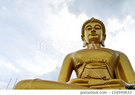"The giant Buddha at Wat Paknam Phasi Charoen in Thailand and a cloudy sky" "The giant Buddha at Wat Paknam Phasi Charoen in Thailand and a cloudy sky" 138949633